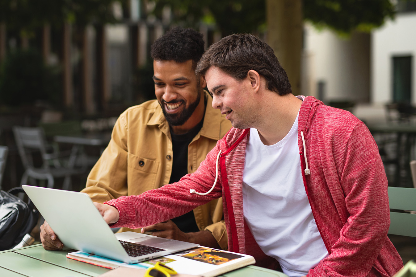 Two men consulting outside